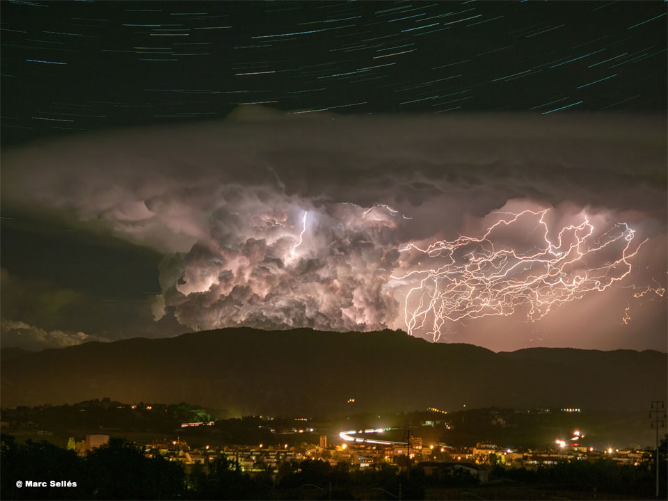 The featured image shows star trails over a lightning
storm over a city.
Please see the explanation for more detailed information.