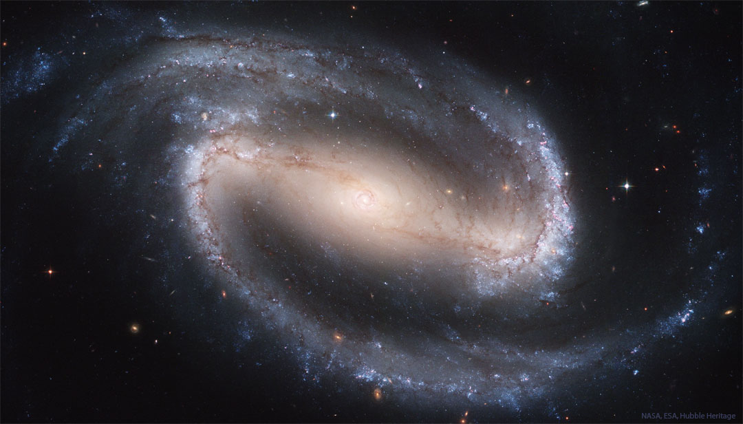 The featured image shows a the big beautiful barred spiral
galaxy NGC 1300 with encompassing spiral arms tinted blue from
young stars.
Please see the explanation for more detailed information.