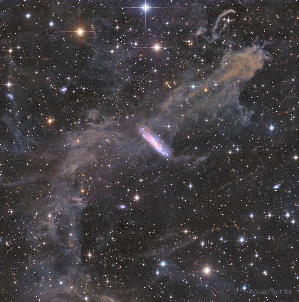 The featured image shows distant spiral galaxy NGC 7497
in a field of foreground stars, gas, and dust. The foreground
gas and dust is in our own Milky Way galaxy and so well in 
front of the galaxy -- but appears to go right through it. 
Please see the explanation for more detailed information.