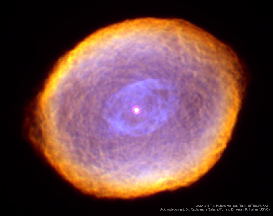A complex orange and purple nebula with a complex
texture is shown in front of a dark starfield.
Więcej szczegółowych informacji w opisie poniżej.