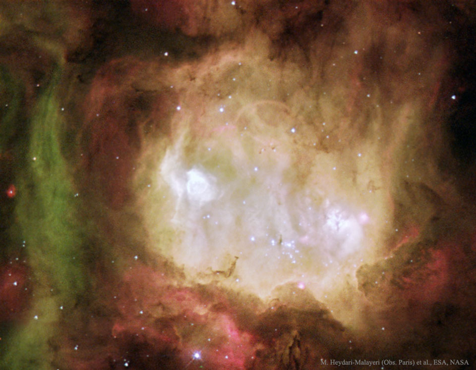 A white nebula appears in a colorful star field. To some,
the nebula appears like a ghost. 
Więcej szczegółowych informacji w opisie poniżej.