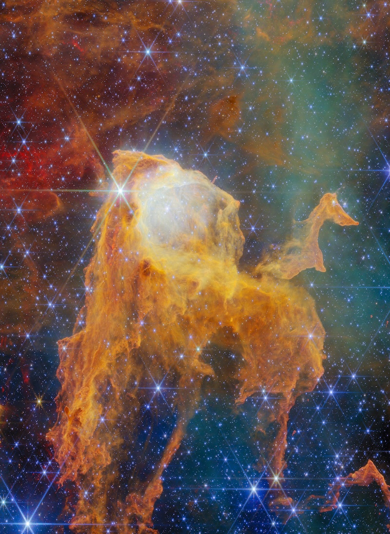 A colorful nebula resembles an open
	  treasure chest on a field of stars.